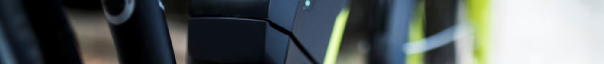 Close-up view of a black and neon green bicycle.