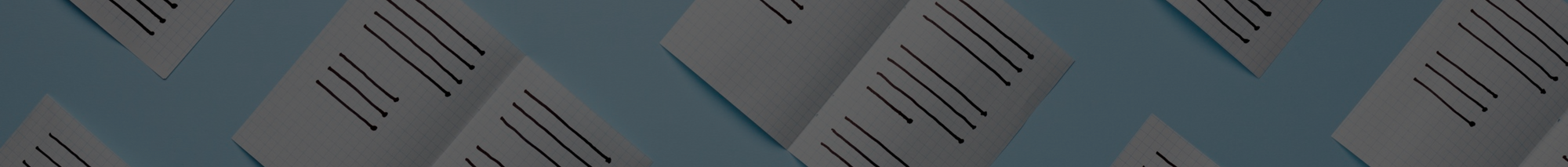 Scattered papers with black lines on a blue surface.