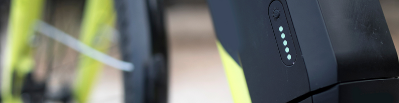 Electric bike battery with five LED indicator lights illuminated, showing a full charge.