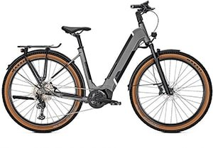 Matte black electric bike with a step-through frame, brown sidewall tires, and a rear rack.